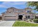Charming two-story home with a large garage, well-kept lawn, and attractive architectural details at 6204 S Banning St, Gilbert, AZ 85298