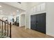 Bright, modern foyer with wood-look floors, gray doors, and shuttered window above the entrance at 6204 S Banning St, Gilbert, AZ 85298