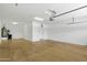 Spacious garage featuring a utility closet with water heater and concrete floors at 6204 S Banning St, Gilbert, AZ 85298