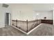 Hallway with hardwood banister, carpet, and views to the lower floor at 6204 S Banning St, Gilbert, AZ 85298