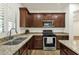 Kitchen with stainless appliances, granite countertops, undermount sink and plantation shutters at 6204 S Banning St, Gilbert, AZ 85298