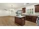 View of kitchen with center island, wood cabinets, granite countertops and stainless appliances at 6204 S Banning St, Gilbert, AZ 85298