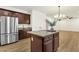 Gourmet kitchen with center island, stainless appliances, and ample cabinet space at 6204 S Banning St, Gilbert, AZ 85298