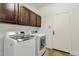 Laundry room with front load washer and dryer and upper storage cabinets at 6204 S Banning St, Gilbert, AZ 85298