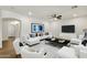 Bright living room featuring modern furniture, recessed lighting, and wood-look flooring at 6204 S Banning St, Gilbert, AZ 85298