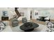 Elegant living area with wood floors, stylish seating, staircase view, and dining area at 6204 S Banning St, Gilbert, AZ 85298