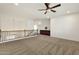 Open loft area features neutral carpet, chandelier, wood railing, and convenient built-in storage at 6204 S Banning St, Gilbert, AZ 85298