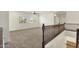 Upstairs loft area with wood railing and bright lighting from windows at 6204 S Banning St, Gilbert, AZ 85298