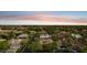 An aerial view of the neighborhood showcasing the lush tree canopy and upscale homes with tile roofs in a community setting at 8336 S Homestead Ln, Tempe, AZ 85284