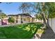 Spacious backyard with green grass and mature trees at 8336 S Homestead Ln, Tempe, AZ 85284