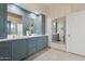 Modern bathroom featuring blue cabinetry, quartz countertops, dual sinks and decorative mirrors at 8336 S Homestead Ln, Tempe, AZ 85284