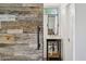 Modern bathroom featuring a sliding barn door, white subway tile, and sleek black fixtures at 8336 S Homestead Ln, Tempe, AZ 85284