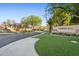 Well-maintained community entrance with lush landscaping and signage at 8336 S Homestead Ln, Tempe, AZ 85284