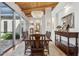 Dining room with hardwood floors, wood ceiling beams, and a view to the outdoor courtyard at 8336 S Homestead Ln, Tempe, AZ 85284