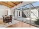 Bright dining area features hardwood floors, access to the courtyard, and custom lighting at 8336 S Homestead Ln, Tempe, AZ 85284