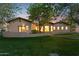 Beautifully landscaped home with a large, green lawn and mature trees at 8336 S Homestead Ln, Tempe, AZ 85284