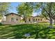 Well-maintained home exterior with a lush green lawn and mature trees at 8336 S Homestead Ln, Tempe, AZ 85284