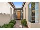 Inviting front entrance featuring a wood door, desert landscaping, and a tiled overhang at 8336 S Homestead Ln, Tempe, AZ 85284