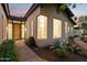 Charming home featuring a solid wood front door, tiled roof, and lush desert landscaping at 8336 S Homestead Ln, Tempe, AZ 85284