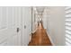 Hallway with gleaming hardwood floors and white doors, bathed in natural light at 8336 S Homestead Ln, Tempe, AZ 85284