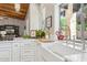 Close up of a kitchen with white cabinets, stainless appliances, and a view from the window at 8336 S Homestead Ln, Tempe, AZ 85284