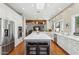 Bright, open kitchen features a large island, stainless steel appliances, and seamless flow to the living area at 8336 S Homestead Ln, Tempe, AZ 85284