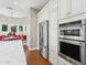 Kitchen featuring stainless steel appliances, modern white cabinets and hardwood floors at 8336 S Homestead Ln, Tempe, AZ 85284