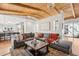 Spacious living room featuring beamed ceilings, a large sectional, and a seamless flow to the kitchen at 8336 S Homestead Ln, Tempe, AZ 85284