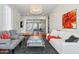 Modern living room with stylish decor, a chic chandelier, and seamless access to additional living space at 8336 S Homestead Ln, Tempe, AZ 85284