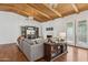 Cozy living room boasts a beamed ceiling, fireplace, built-in shelving and hardwood floors at 8336 S Homestead Ln, Tempe, AZ 85284