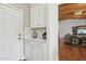 Welcoming mudroom with custom cabinets, quartz countertop, and open living space at 8336 S Homestead Ln, Tempe, AZ 85284