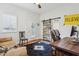 Bright office with a sliding barn door, modern décor, and a comfortable seating area at 8336 S Homestead Ln, Tempe, AZ 85284
