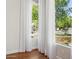 Window view from room featuring shear curtains, natural light and lush greenery at 8336 S Homestead Ln, Tempe, AZ 85284