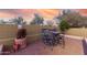 Desert backyard featuring a full outdoor dining set and hardscaped perimeter at 8542 E Indigo St, Mesa, AZ 85207