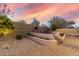 Spacious backyard with stepped patios, desert landscaping, and perimeter wall at 8542 E Indigo St, Mesa, AZ 85207