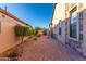 Backyard patio area with brick pavers, outdoor furniture, and mature landscaping at 8542 E Indigo St, Mesa, AZ 85207