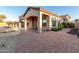 Beautiful outdoor living space with covered patio, seating area, and brick pavers at 8542 E Indigo St, Mesa, AZ 85207