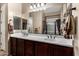 Bathroom features a double sink vanity, large mirror, and a view to the shower at 8542 E Indigo St, Mesa, AZ 85207