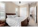 Well-lit bedroom featuring carpet, ceiling fan, and view to an open doorway with natural light at 8542 E Indigo St, Mesa, AZ 85207