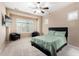 Bright bedroom featuring plush carpet, plantation shutters, and a modern ceiling fan at 8542 E Indigo St, Mesa, AZ 85207