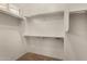 Walk-in closet provides ample storage space with multiple shelving units and custom organizers at 8542 E Indigo St, Mesa, AZ 85207