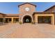 Elegant clubhouse featuring classic architecture, a prominent clock tower, and covered entryways with beautiful brick paving at 8542 E Indigo St, Mesa, AZ 85207