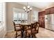 Charming dining area featuring plantation shutters and dark wood table with padded chairs at 8542 E Indigo St, Mesa, AZ 85207