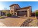 Beautiful home with a two-car garage, brick driveway, and well-maintained landscaping at 8542 E Indigo St, Mesa, AZ 85207