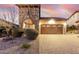 Home exterior featuring stone accents, desert landscaping, and a brick driveway at 8542 E Indigo St, Mesa, AZ 85207