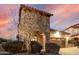 Home exterior featuring stone accents, desert landscaping, and driveway pavers at 8542 E Indigo St, Mesa, AZ 85207