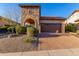 Home exterior showcasing stone accents, desert landscaping, and a brick driveway at 8542 E Indigo St, Mesa, AZ 85207