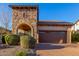 Home exterior showcasing stone accents, desert landscaping, and a brick driveway at 8542 E Indigo St, Mesa, AZ 85207
