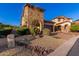 Home exterior featuring stone accents, desert landscaping, and driveway pavers at 8542 E Indigo St, Mesa, AZ 85207