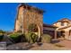 Charming stone-accented home featuring desert landscaping and a two-car garage at 8542 E Indigo St, Mesa, AZ 85207